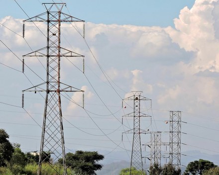 Electricity transmission tower against a dark sky